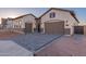 Single-story home showcasing a brick-accented facade, a paved driveway, and a warm, inviting aesthetic at 2636 E Virginia St, Mesa, AZ 85213