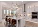 Bright, open kitchen featuring a large island, white cabinetry, stainless steel appliances, and pendant lighting at 2636 E Virginia St, Mesa, AZ 85213