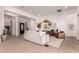 Open-concept living area with modern furnishings, neutral tones, a black door, and seamless flow throughout at 2636 E Virginia St, Mesa, AZ 85213