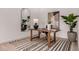 Modern office with wood desk, black and white rug, arched mirror, and a decorative plant at 2636 E Virginia St, Mesa, AZ 85213