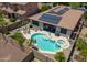 Aerial view of solar panels, backyard pool, patio, and desert landscaping at 271 W Key West W Dr, Casa Grande, AZ 85122