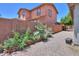 The backyard has gravel, a garden, and a two-story home at 271 W Key West W Dr, Casa Grande, AZ 85122