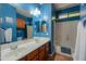Stylish blue bathroom featuring a dual sink vanity, soaking tub, and eye-catching tile accents at 271 W Key West W Dr, Casa Grande, AZ 85122