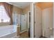 Bathroom featuring a glass-enclosed shower, a soaking tub, and ceramic tile floor at 271 W Key West W Dr, Casa Grande, AZ 85122