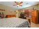 A cozy bedroom with warm tones and furniture, carpet and ceiling fan at 271 W Key West W Dr, Casa Grande, AZ 85122