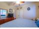 Bright bedroom featuring a full dresser, cozy bed, and a ceiling fan for comfort at 271 W Key West W Dr, Casa Grande, AZ 85122