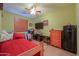 Cozy bedroom with a ceiling fan, mounted TV, dresser and carpet flooring at 271 W Key West W Dr, Casa Grande, AZ 85122