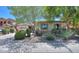 Single-story home with a well-maintained yard featuring lush landscaping and mature trees at 271 W Key West W Dr, Casa Grande, AZ 85122