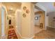 A brightly lit hallway with decorative rugs, leading to various rooms in the home at 271 W Key West W Dr, Casa Grande, AZ 85122