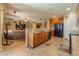 Spacious kitchen with granite island, wood cabinets, and adjacent living area at 271 W Key West W Dr, Casa Grande, AZ 85122