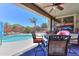 Inviting covered patio featuring a ceiling fan and ornate furniture, with a pool just beyond at 271 W Key West W Dr, Casa Grande, AZ 85122