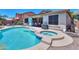 A backyard with a pool, spa, and covered patio at 271 W Key West W Dr, Casa Grande, AZ 85122