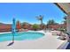 Beautiful backyard pool area featuring palm trees and outdoor seating at 271 W Key West W Dr, Casa Grande, AZ 85122
