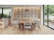 Elegant dining room featuring a large table, modern chairs, and stylish wine rack at 3828 E Monterosa St, Phoenix, AZ 85018