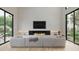 Bright living room with modern fireplace, large windows, and comfortable sectional sofa at 3828 E Monterosa St, Phoenix, AZ 85018