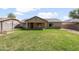 Expansive backyard featuring lush green grass, a covered patio, and well-maintained landscaping at 40020 N Cape Wrath Dr Dr, San Tan Valley, AZ 85140