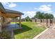 Large backyard featuring lush lawn, covered patio, a privacy fence and garden at 40020 N Cape Wrath Dr Dr, San Tan Valley, AZ 85140