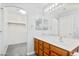 Bathroom featuring modern vanity, large mirror, and walk-in closet at 40020 N Cape Wrath Dr Dr, San Tan Valley, AZ 85140