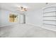 This bedroom features a ceiling fan, plush carpet, natural light, and built in shelving at 40020 N Cape Wrath Dr Dr, San Tan Valley, AZ 85140