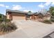Attractive one-story home with brick accents, a two-car garage, and a spacious concrete driveway at 40020 N Cape Wrath Dr Dr, San Tan Valley, AZ 85140