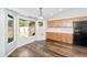 Bright kitchen boasts wood cabinets, modern black refrigerator, wood flooring, and a large bay window at 40020 N Cape Wrath Dr Dr, San Tan Valley, AZ 85140
