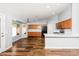 Open-concept kitchen featuring wood cabinets, white countertops, and modern appliances at 40020 N Cape Wrath Dr Dr, San Tan Valley, AZ 85140
