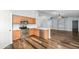 Open concept kitchen with stainless steel appliances, wood cabinets, island, and wood floors at 40020 N Cape Wrath Dr Dr, San Tan Valley, AZ 85140