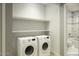 A stylish and functional laundry room with storage shelves and modern appliances at 40020 N Cape Wrath Dr Dr, San Tan Valley, AZ 85140