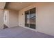 Covered back patio with concrete floor and a sliding glass door at 40030 W Bunker Dr, Maricopa, AZ 85138