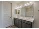 Bright bathroom featuring a double vanity sink, modern fixtures, and well-lit mirror at 40030 W Bunker Dr, Maricopa, AZ 85138