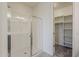 Shower area featuring a seamless glass door, with a walk-in closet to the rear at 40030 W Bunker Dr, Maricopa, AZ 85138
