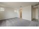 Bright bedroom showcasing soft carpeting, white walls, and windows offering views at 40030 W Bunker Dr, Maricopa, AZ 85138