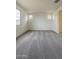 Bedroom featuring soft carpeting, white walls, and windows providing natural light at 40030 W Bunker Dr, Maricopa, AZ 85138