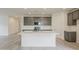 Modern kitchen featuring a large island with white quartz countertops, grey cabinets, and stainless steel appliances at 40030 W Bunker Dr, Maricopa, AZ 85138