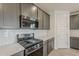 Close-up of a modern kitchen with stainless steel gas range, microwave, and subway tile backsplash at 40030 W Bunker Dr, Maricopa, AZ 85138