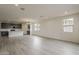 Bright and airy living room with recessed lighting and views into the open concept kitchen at 40030 W Bunker Dr, Maricopa, AZ 85138