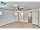 Bright and airy bedroom with carpet flooring, ceiling fan, walk-in closet and ensuite bathroom entrance at 4252 E Vest Ave, Gilbert, AZ 85295