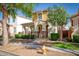 Inviting two-story home with covered porch, stone accents, desert landscaping, and mature shade tree at 4252 E Vest Ave, Gilbert, AZ 85295