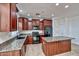 Modern kitchen featuring granite countertops, a central island, and sleek black appliances at 4252 E Vest Ave, Gilbert, AZ 85295