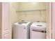 Laundry room with white washer and dryer and a shelf above them at 4252 E Vest Ave, Gilbert, AZ 85295