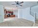 Spacious living area with carpet flooring next to kitchen area with tile and a staircase to the second floor at 4252 E Vest Ave, Gilbert, AZ 85295