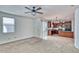 Open-concept living room with carpet flooring flowing seamlessly into the kitchen and access to the back patio at 4252 E Vest Ave, Gilbert, AZ 85295