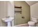 Unique powder room with a pedestal sink, industrial style shelving and a tiled floor at 4252 E Vest Ave, Gilbert, AZ 85295