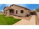 A well-maintained backyard features a covered patio, lush green grass, and low maintenance landscaping at 4255 S Marisol Ln, Gilbert, AZ 85297