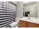 This bathroom features a black and white striped shower curtain and light wood cabinets at 4255 S Marisol Ln, Gilbert, AZ 85297