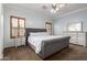 This bedroom features an upholstered bedframe, decorative shuttered windows, and a dresser at 4255 S Marisol Ln, Gilbert, AZ 85297
