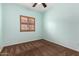 Carpeted bedroom featuring a modern ceiling fan and a large window with shutters at 4255 S Marisol Ln, Gilbert, AZ 85297