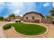 Well maintained front yard exhibiting circular green grass with surrounding desert landscaping at 4255 S Marisol Ln, Gilbert, AZ 85297