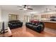Comfortable living room with hardwood floors, ceiling fan, and a seamless transition to dining area at 4255 S Marisol Ln, Gilbert, AZ 85297