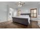 Spacious main bedroom featuring a ceiling fan, plush carpet and a large arched doorway at 4255 S Marisol Ln, Gilbert, AZ 85297